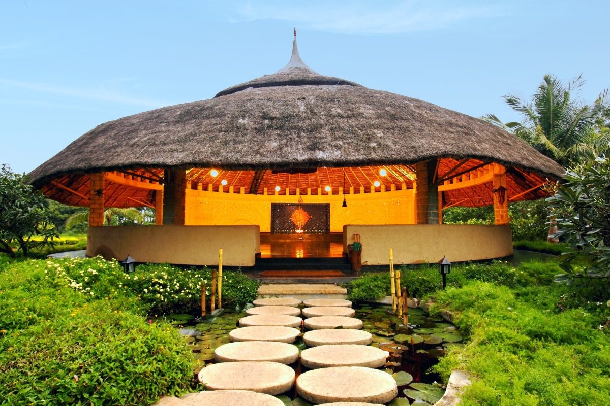 Soukya's Thatched Yoga Hall Set Above A Lily Pond